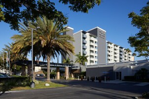 A multi-story hotel with a modern design, featuring a prominent sign on the building.