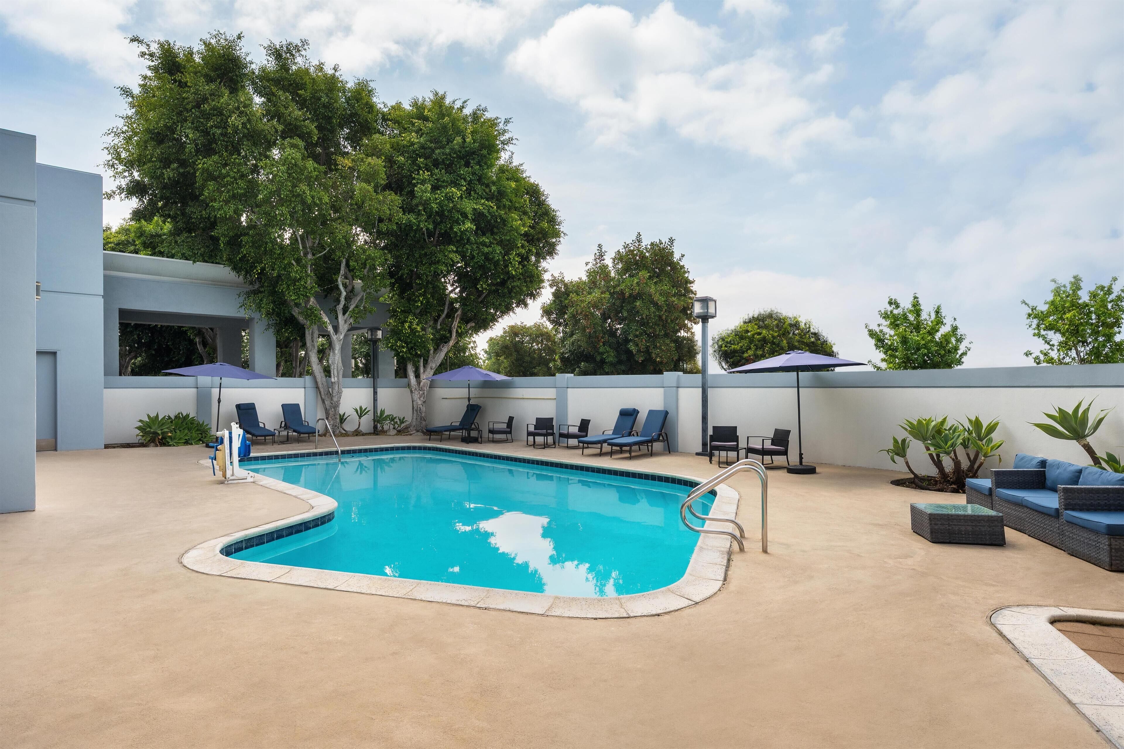 Outdoor pool, open 7:00 AM to 10:00 PM, pool umbrellas, sun loungers