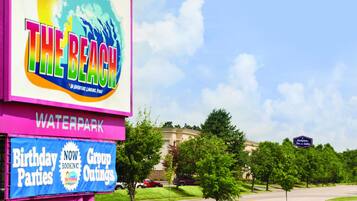 A sign for 'The Beach' with a waterpark, mentioning birthday parties and group outings.