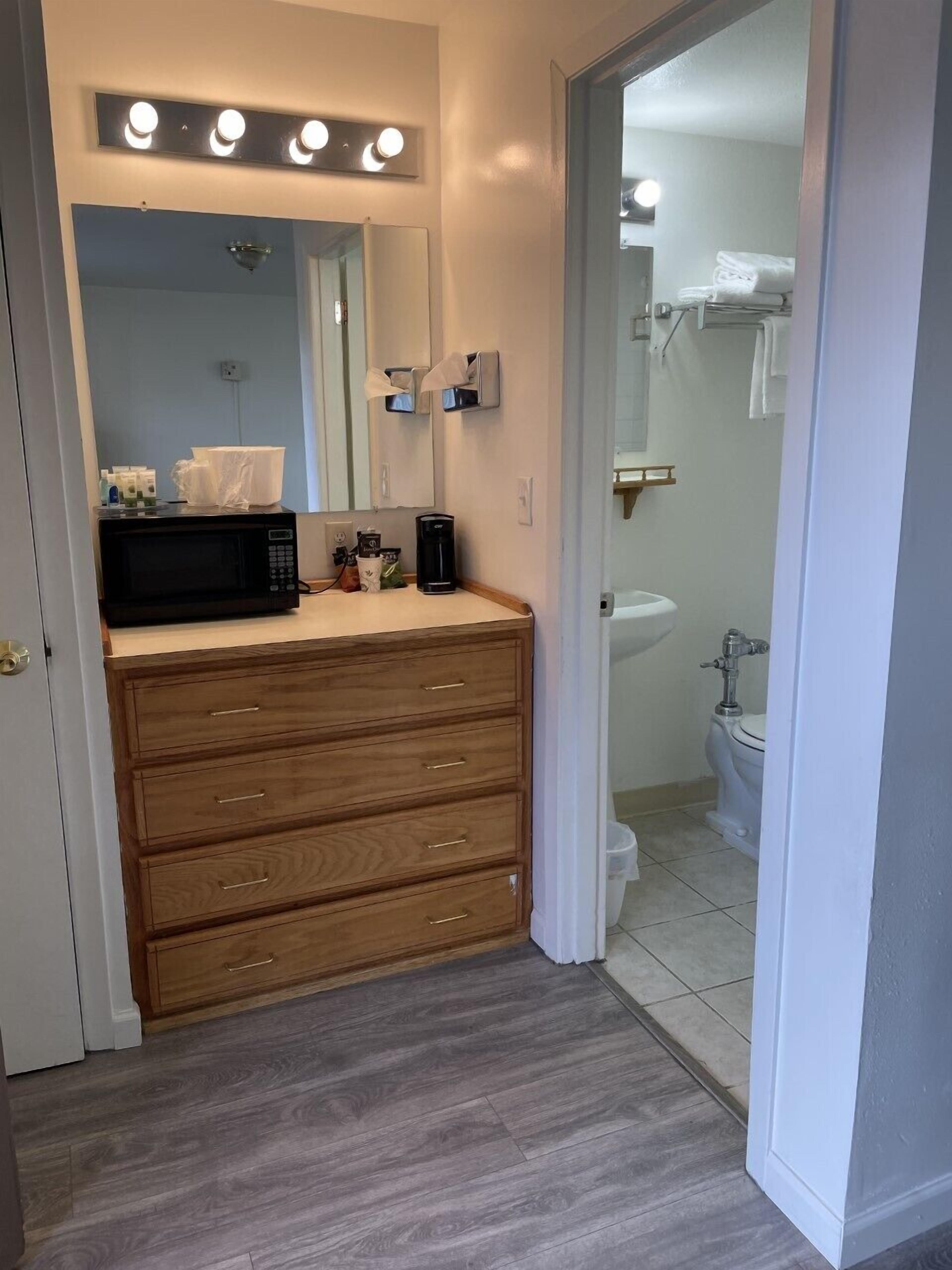 A bathroom with a vanity, a sink, and a toilet.