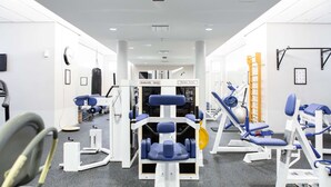 A gym with various exercise equipment, including weight machines and a treadmill. - Scandic Helsinki Aviapolis (Vantaa)
