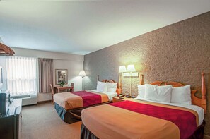 A hotel room with two beds, a desk, a chair, and a large window with curtains. - Econo Lodge Metro (Arlington)