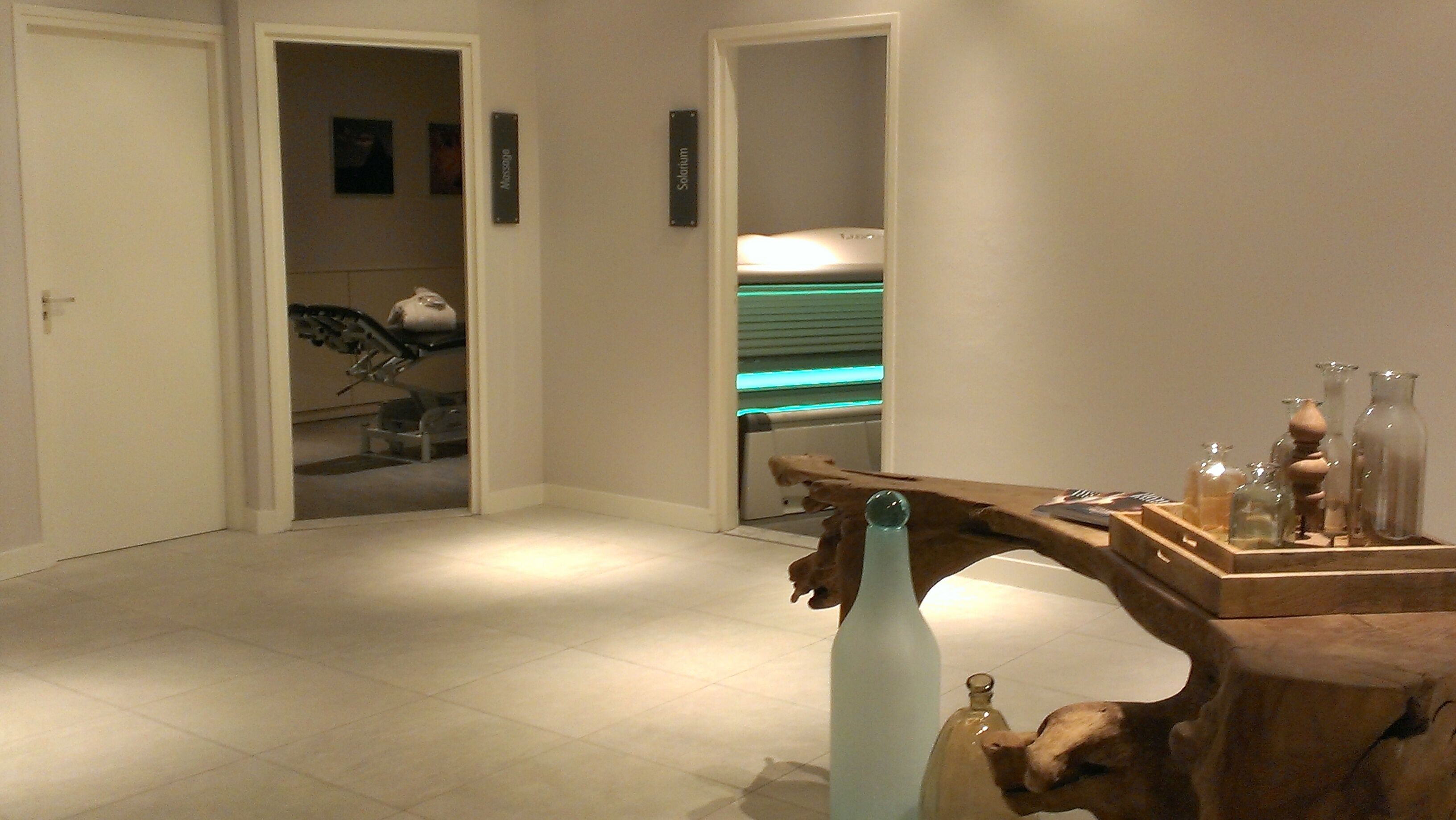 A hallway with a reception desk, a reception area, and a door leading to a room.