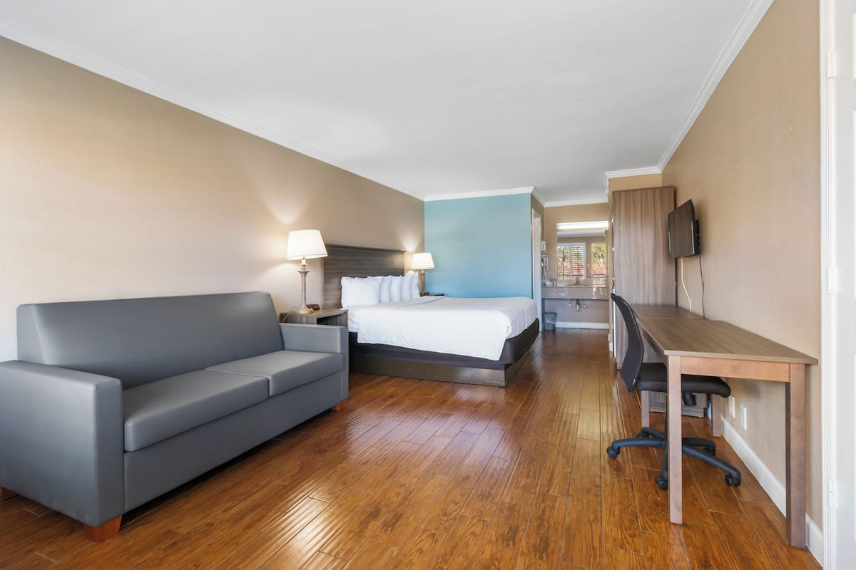 Deluxe Room, 1 King Bed, Pool View | 1 bedroom, premium bedding, in-room safe, individually decorated