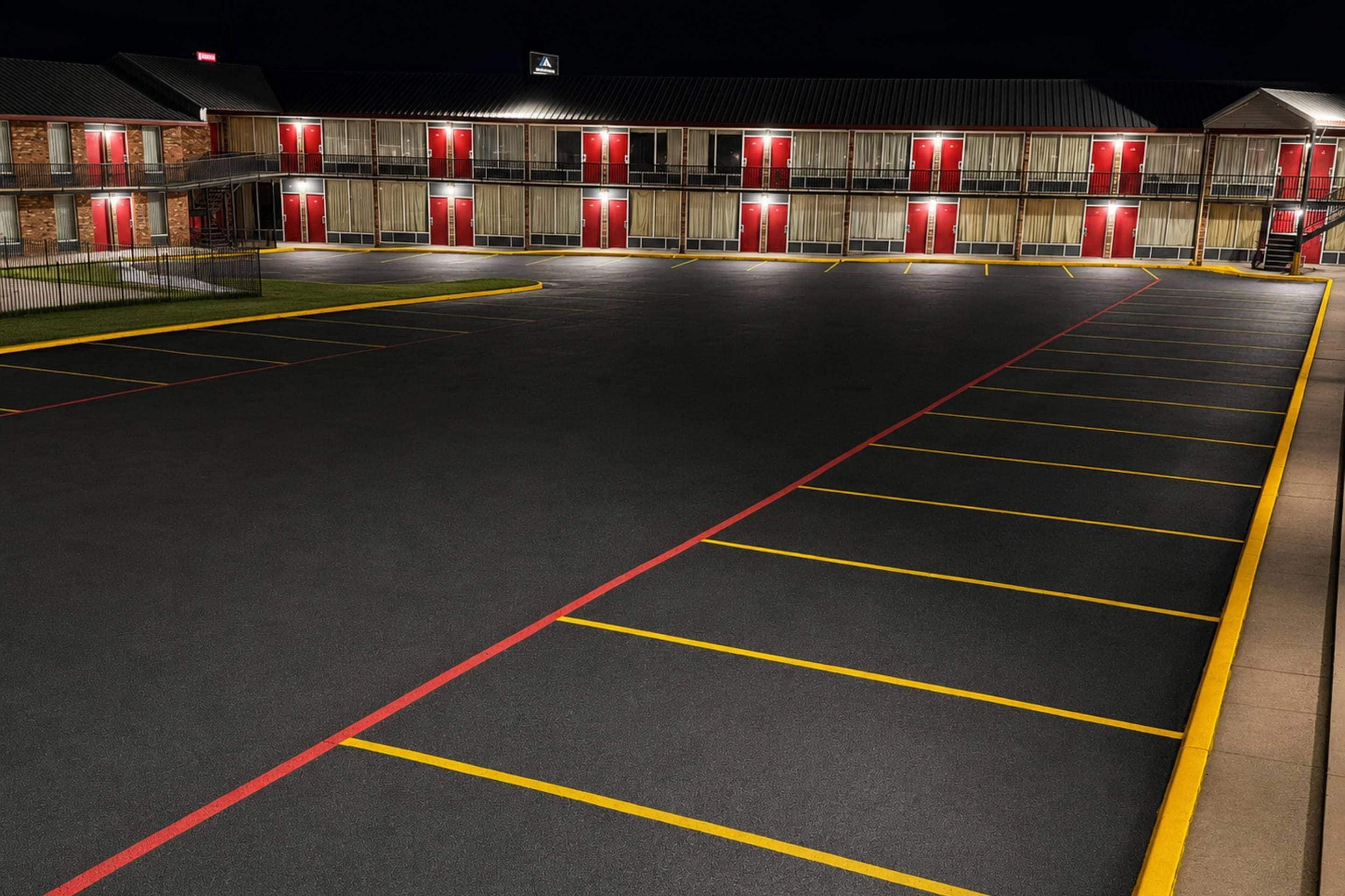 A multi-story motel with a parking lot.