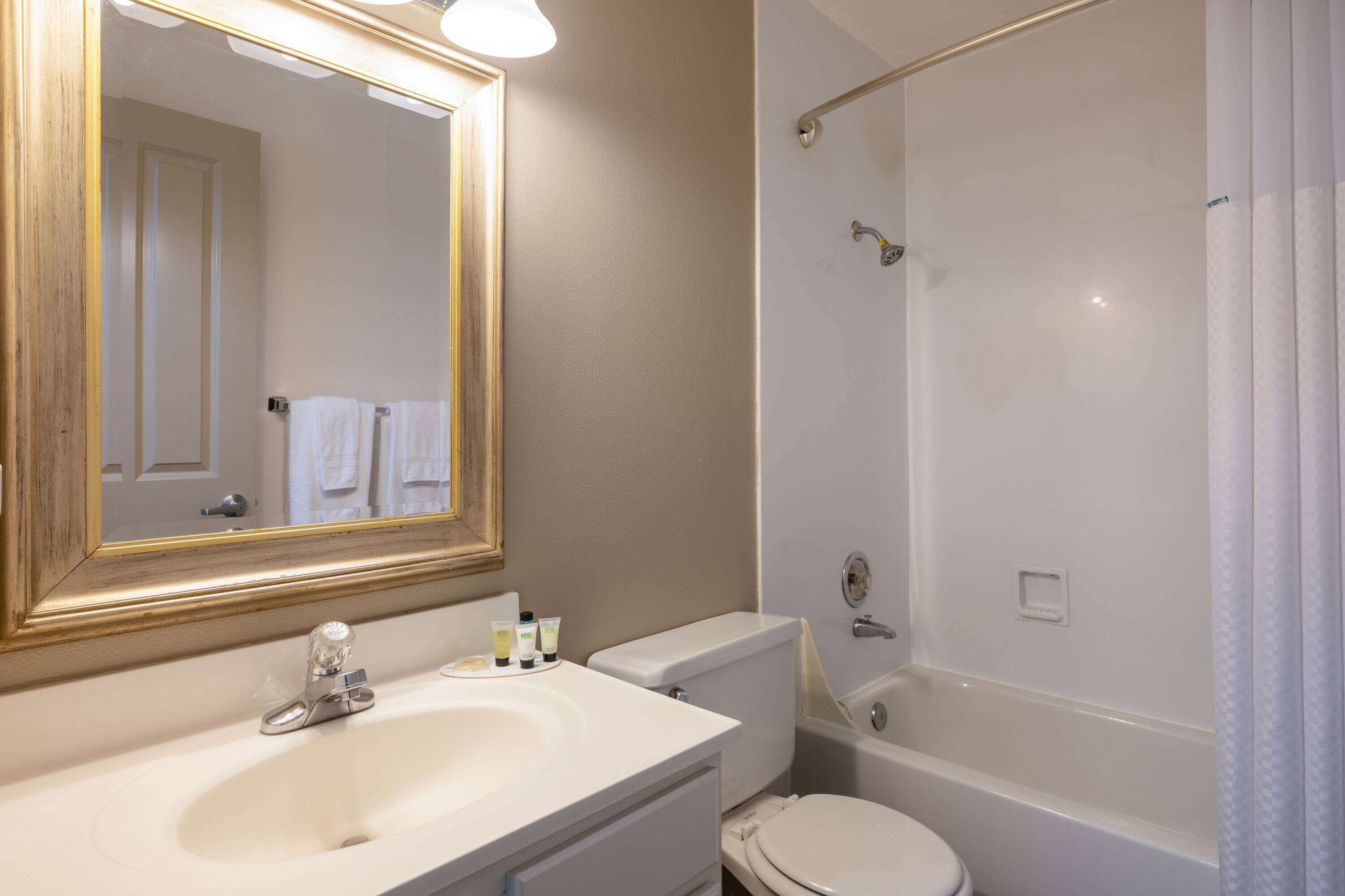 Un baño con lavamanos, inodoro y bañera.