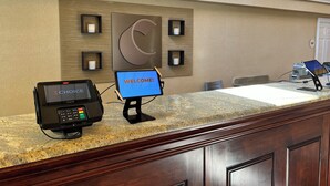 A reception desk with a digital screen displaying "WELCOME!" and a payment terminal labeled "CHOICE". - Comfort Inn Springfield (Springfield)