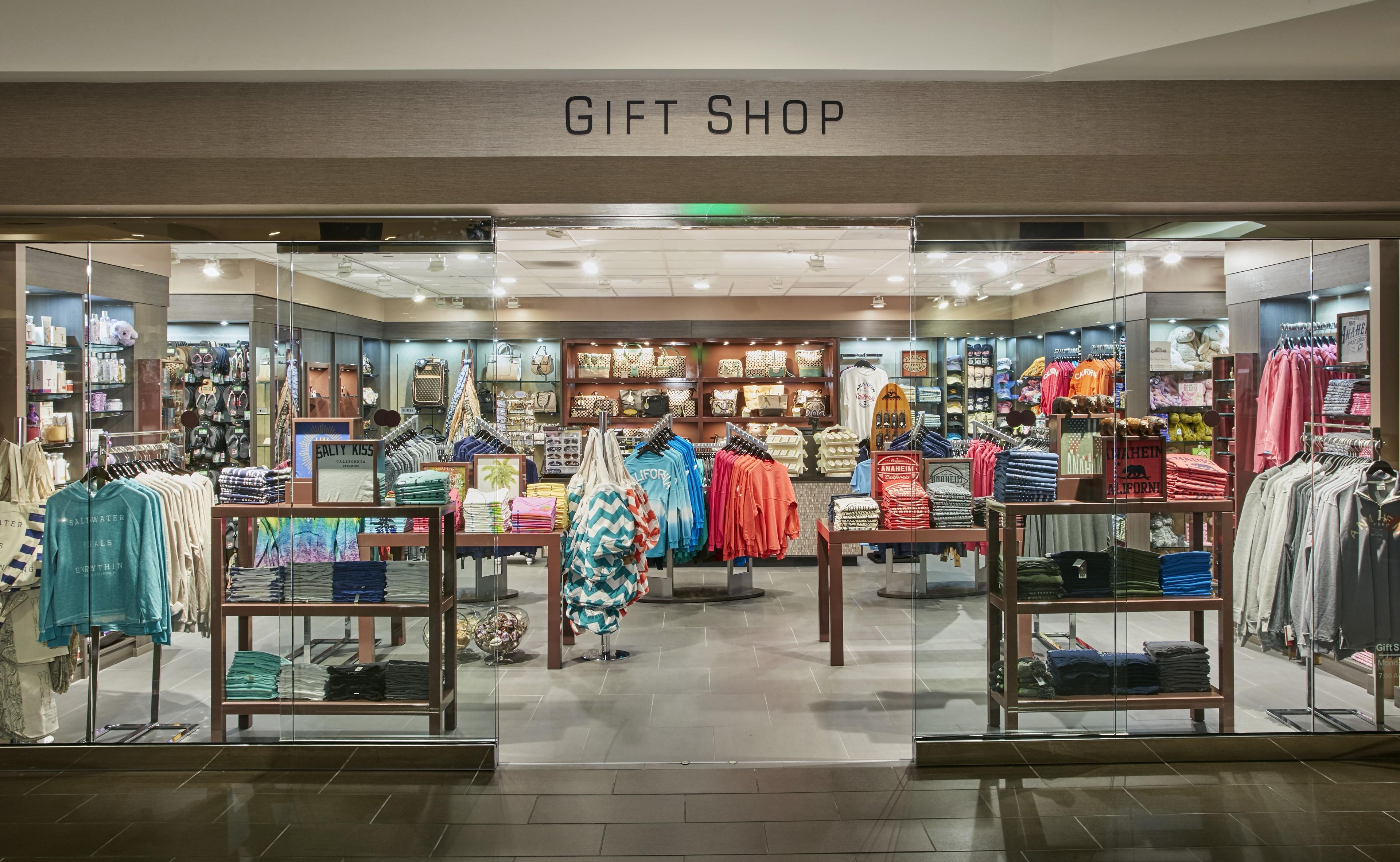 A gift shop with various clothing items and accessories on display.