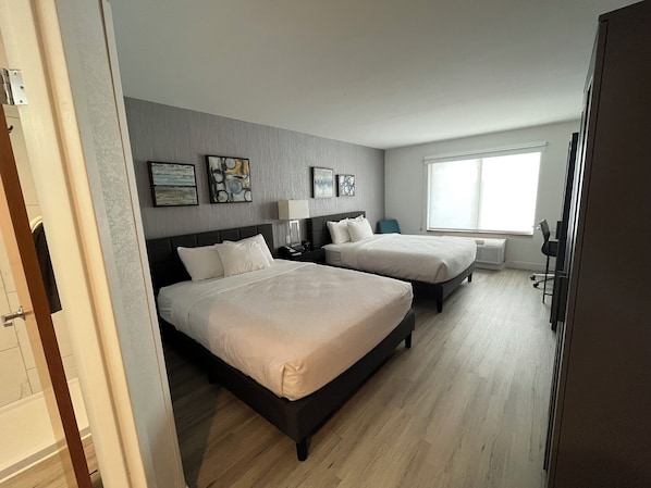 A hotel room with two beds, a large window, and artwork on the walls. - Revival Scottsdale Studios (Scottsdale)
