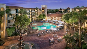 A resort with a central pool, outdoor seating, and a fountain. - Embassy Suites by Hilton Scottsdale Resort (Scottsdale)