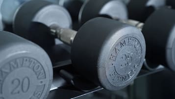A close-up of a weightlifting dumbbell with the inscription "HAMPTON FITNESS" and the number "25".