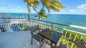 A balcony with a view of the ocean, a table, chairs, and a railing. - Hyatt Centric Key West Resort and Spa (Key West)