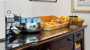 A breakfast buffet setup with various food items and beverages. - Fitzgerald Hotel (San Francisco)