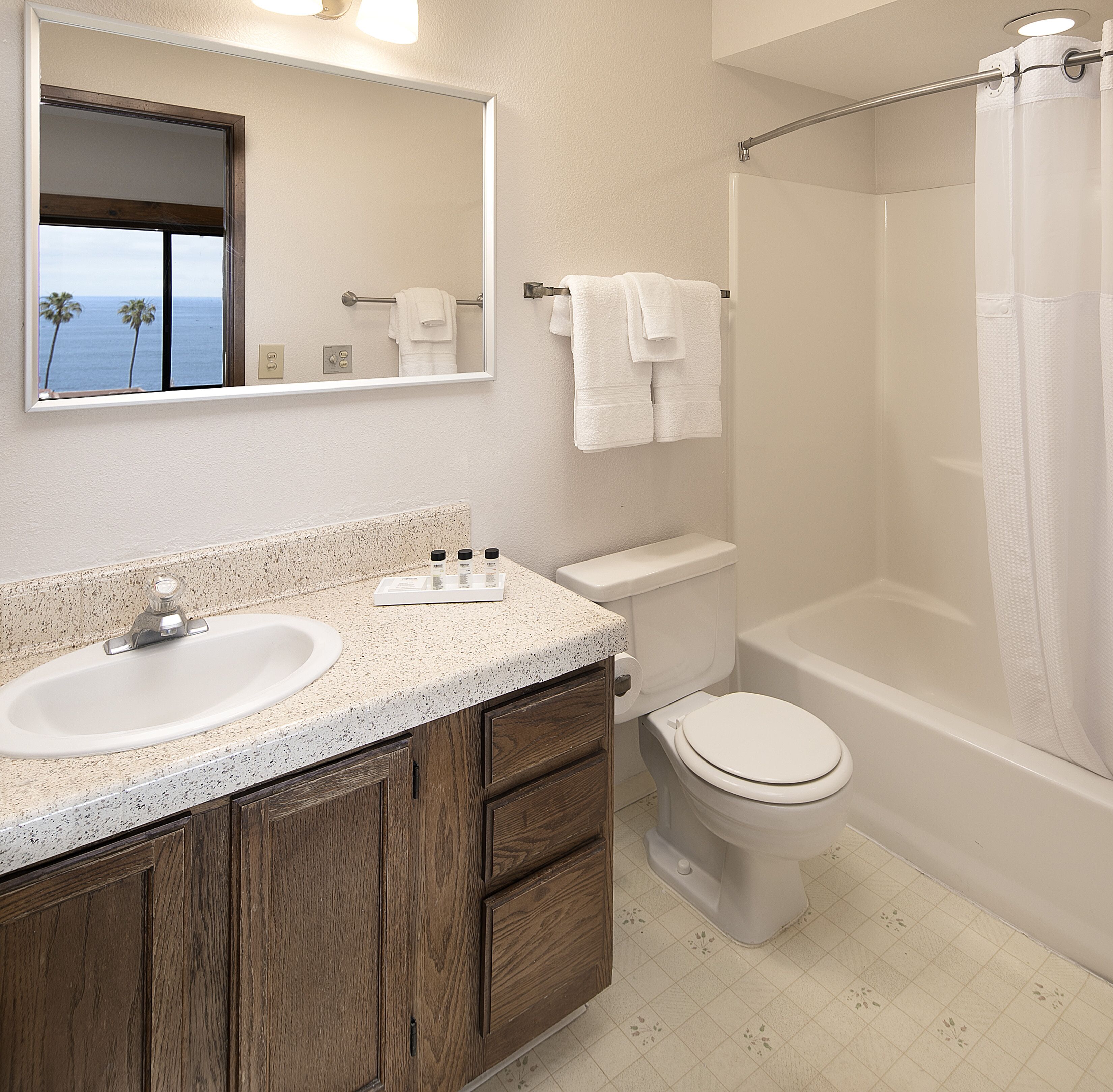 A bathroom with a sink, toilet, and bathtub.