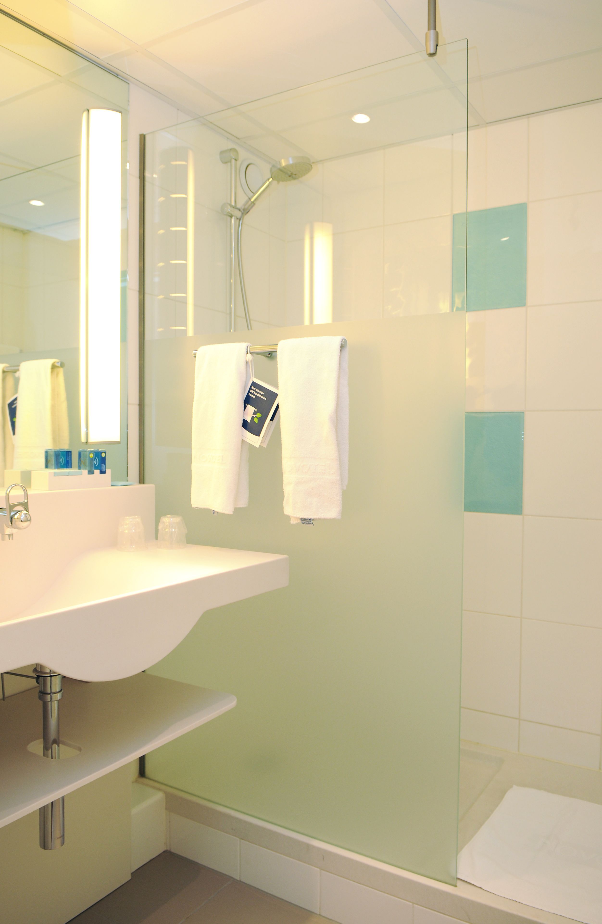 rainfall showerhead, eco-friendly toiletries, hair dryer, towels