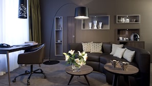First Class Suite | Living area | 36-inch LCD TV with cable channels, stereo