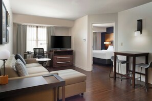 A hotel room with a sofa, a TV, a desk, and a bed. - Residence Inn By Marriott San Antonio Airport/Alamo Heights (San Antonio)