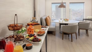 A breakfast buffet with various fruits, pastries, and beverages. - DoubleTree Suites by Hilton Hotel Boston - Cambridge (Boston)
