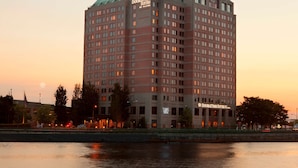 A high-rise hotel with multiple floors, a prominent sign reading "DoubleTree Suites by Hilton," and a waterfront view. - DoubleTree Suites by Hilton Hotel Boston - Cambridge (Boston)