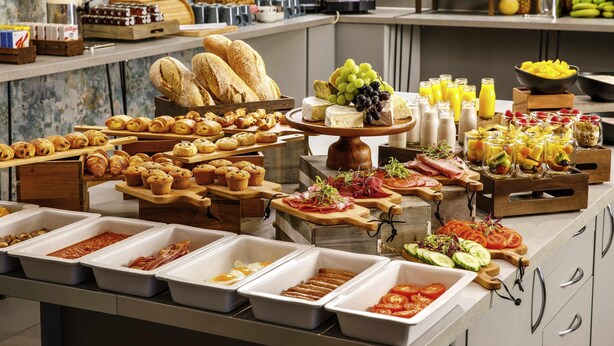 A buffet with various food items, including pastries, cheeses, fruits, and beverages. - The Harlow Hotel By AccorHotels (Harlow)