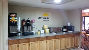 A breakfast bar with a Daybreak sign, coffee machines, a microwave, and a toaster. - Days Inn by Wyndham West Memphis (West Memphis)