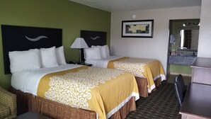 A hotel room with two beds, a desk, a chair, a mirror, and a framed picture on the wall. - Days Inn by Wyndham West Memphis (West Memphis)
