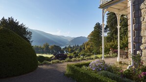 A garden pathway leading to a stone building with a balcony. - Macdonald Leeming House (Penrith)