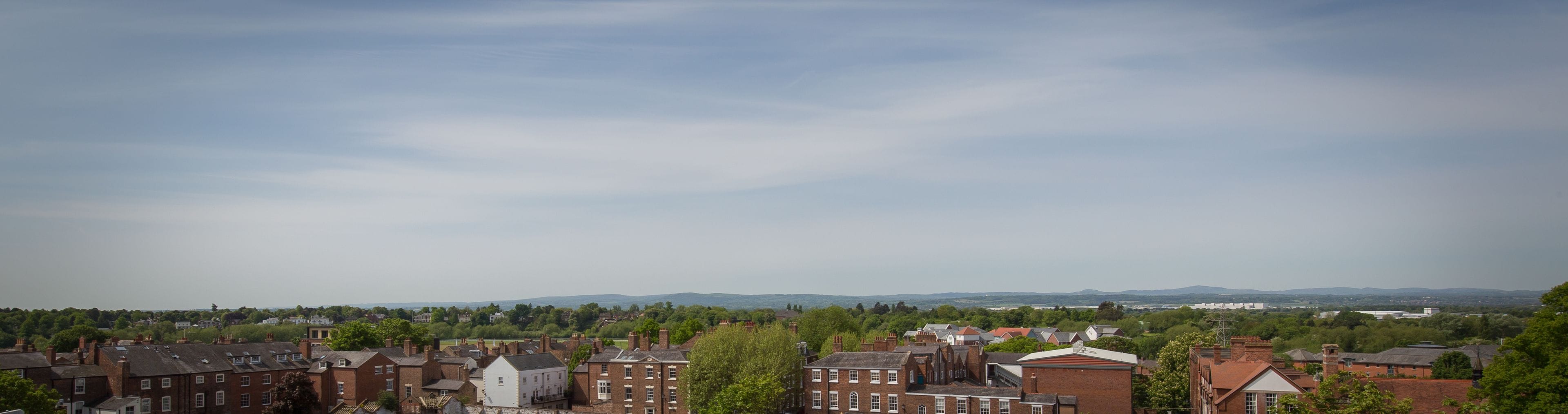 A town with a mix of residential and commercial buildings, including a prominent white building with a pointed roof.