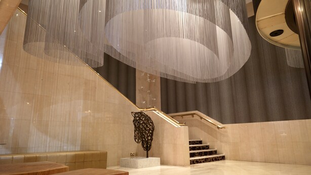 A modern interior with a marble staircase, a seating area, and a decorative wall piece. - Crowne Plaza Chester by IHG (Chester)