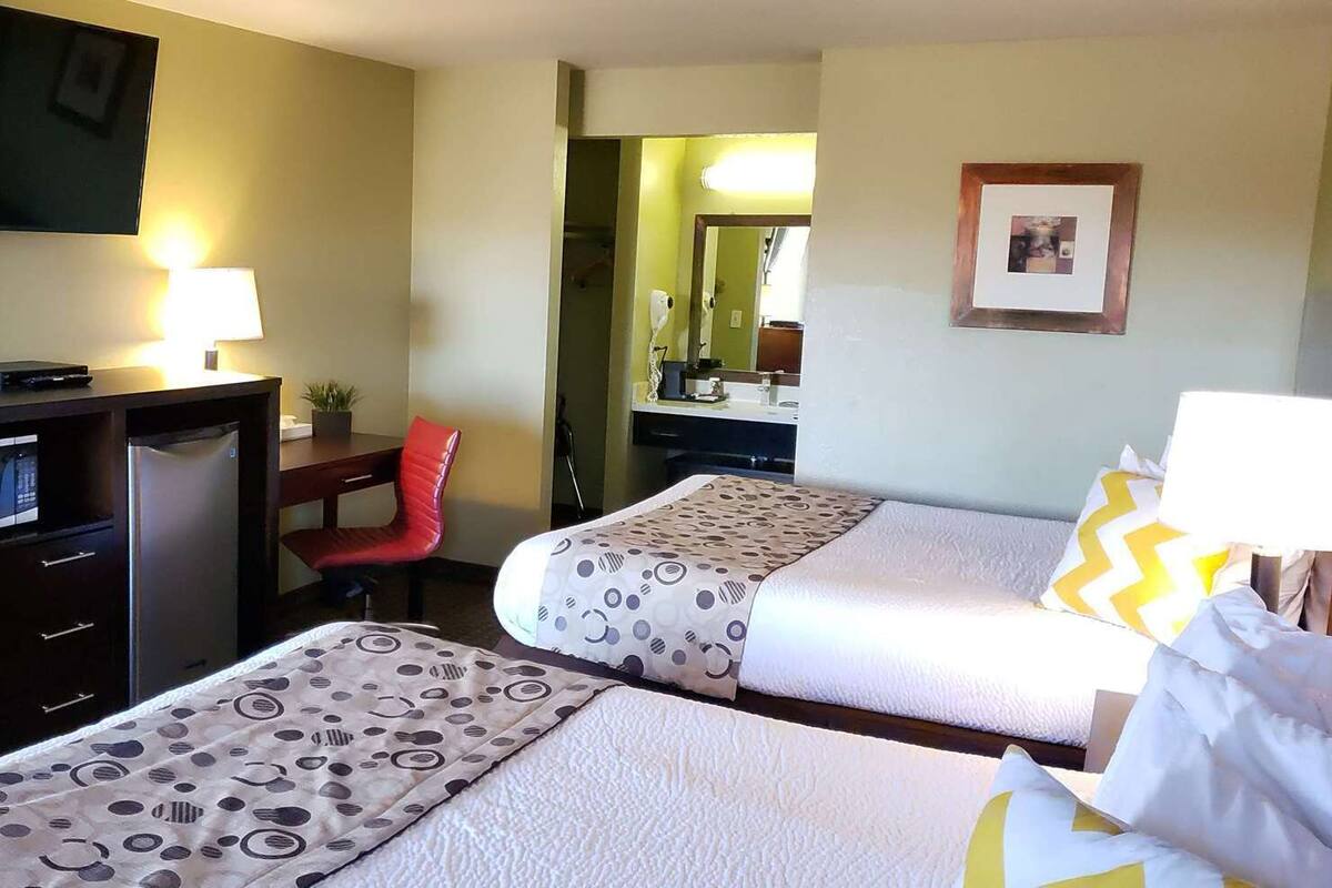 Premium bedding, desk, laptop workspace, blackout curtains