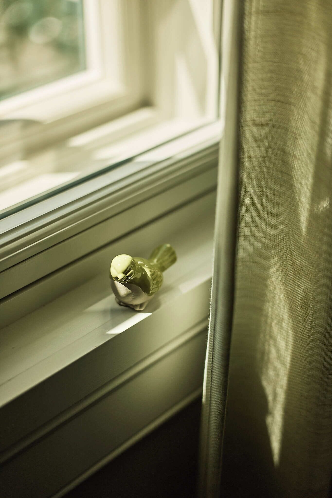 A window with a decorative item on the sill.
