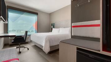 Premium bedding, desk, laptop workspace, blackout curtains
