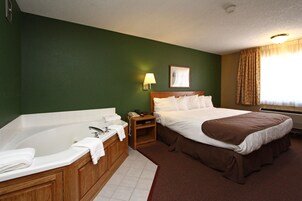 Suite, 1 King Bed, Jetted Tub | Desk, laptop workspace, blackout drapes, iron/ironing board