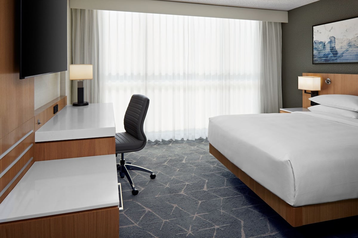 Premium bedding, desk, laptop workspace, blackout drapes