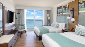 A hotel room with two beds, a TV, a desk, and a view of the ocean. - The Lucie (Jensen Beach)