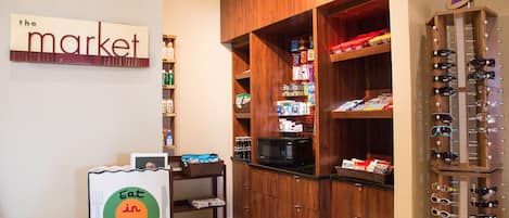 A kitchen with wooden cabinets, a microwave, and a wine rack.