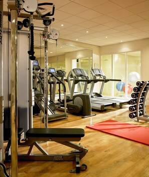 Stay fit on the go with a fully equipped gym featuring treadmills, a bench press, and free weights.