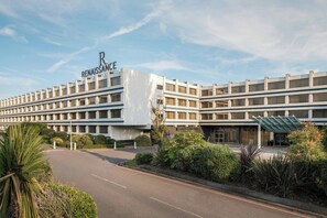 Experience the Renaissance charm of this elegant hotel, featuring a symmetrical design with multiple levels of windows and a flat roof.
