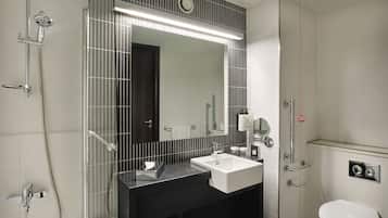 A modern bathroom with a bathtub, a sink, and a toilet.