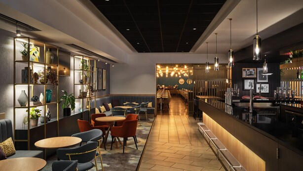 Een moderne bar met zitplaatsen en een lange toonbank.