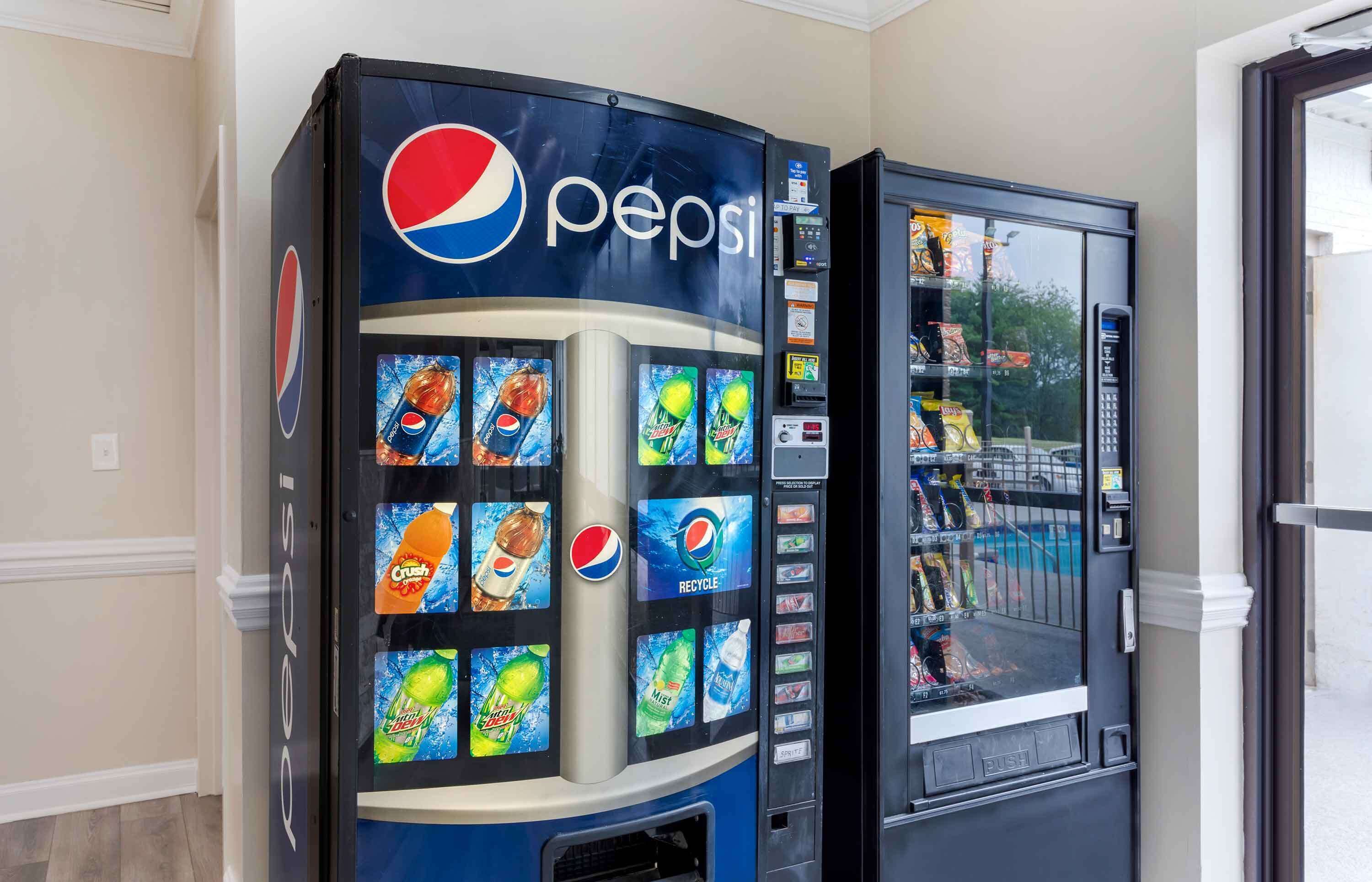 A Pepsi vending machine with various drink options and a recycling symbol.