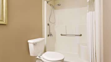 A bathroom with a toilet, a shower with a glass door, and a bathtub.