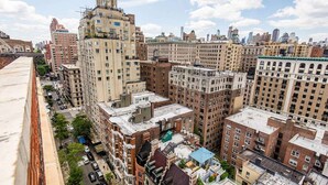 A high-rise building with multiple floors, large windows, and a flat roof. - Riverside Tower Hotel (New York)