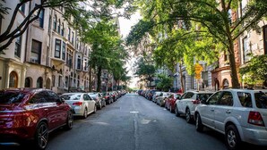 A tree-lined street with parked cars and historic buildings. - Riverside Tower Hotel (New York)