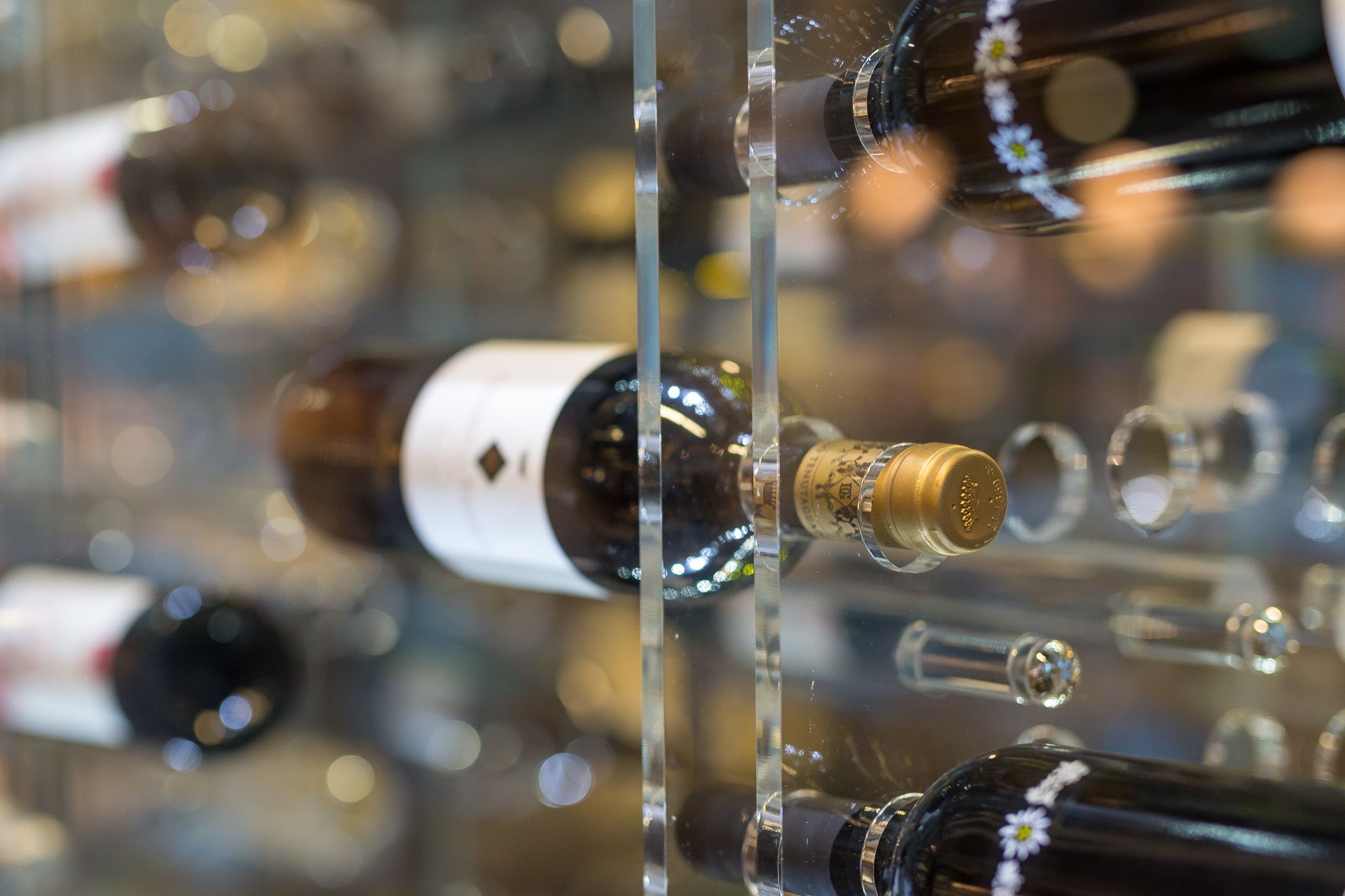 A collection of wine bottles displayed in a clear case.