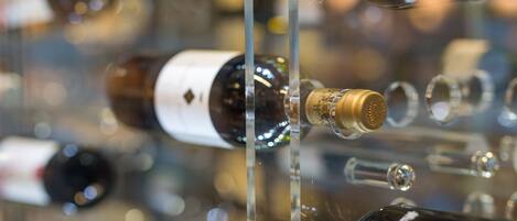 A collection of wine bottles displayed in a clear case.