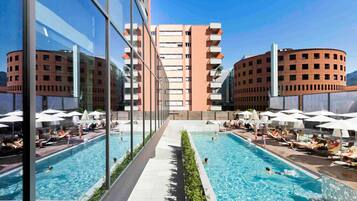 Seasonal outdoor pool, open 8:00 AM to 8:00 PM, pool umbrellas