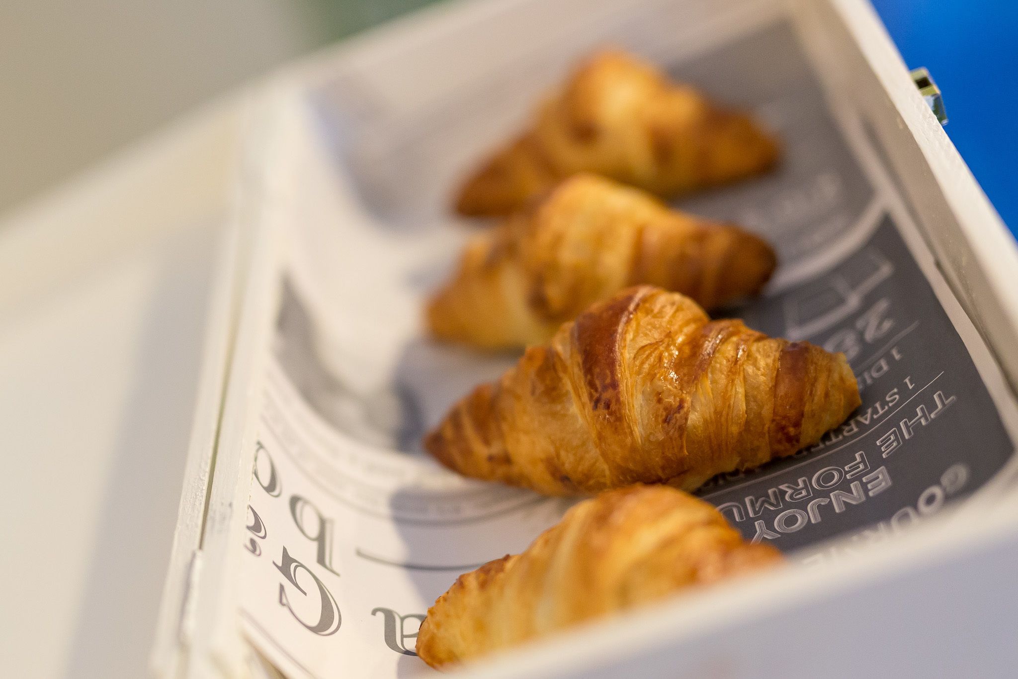 A box of croissants on a table.