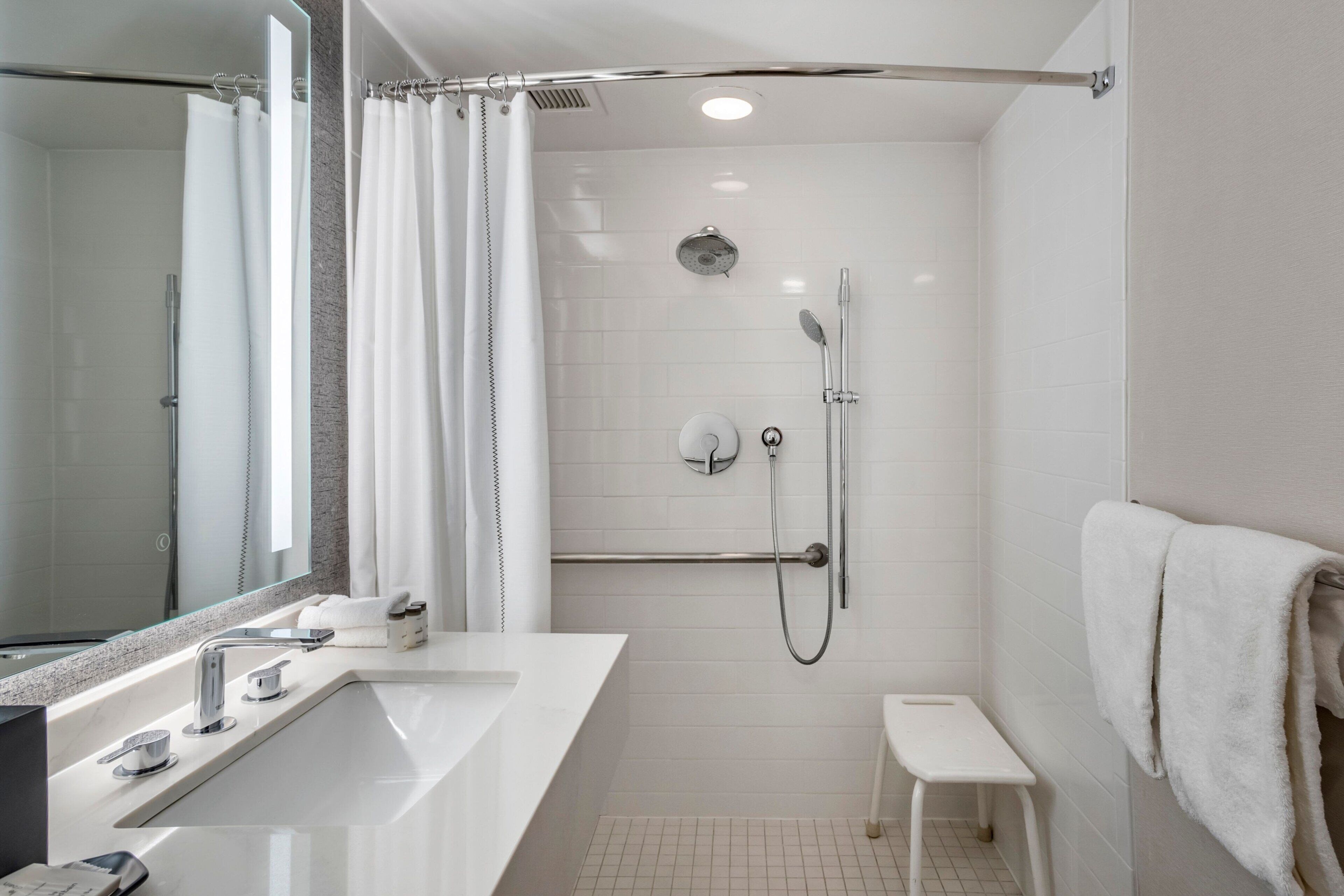 suite, 1 bedroom, balcony (mobility/hearing access, roll-in shwr) | bathroom | combined shower/bathtub, eco-friendly toiletries, hair dryer, towels