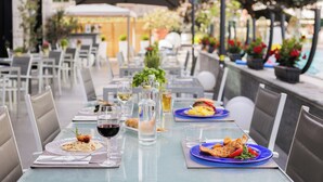 An outdoor dining area with tables, chairs, and umbrellas.